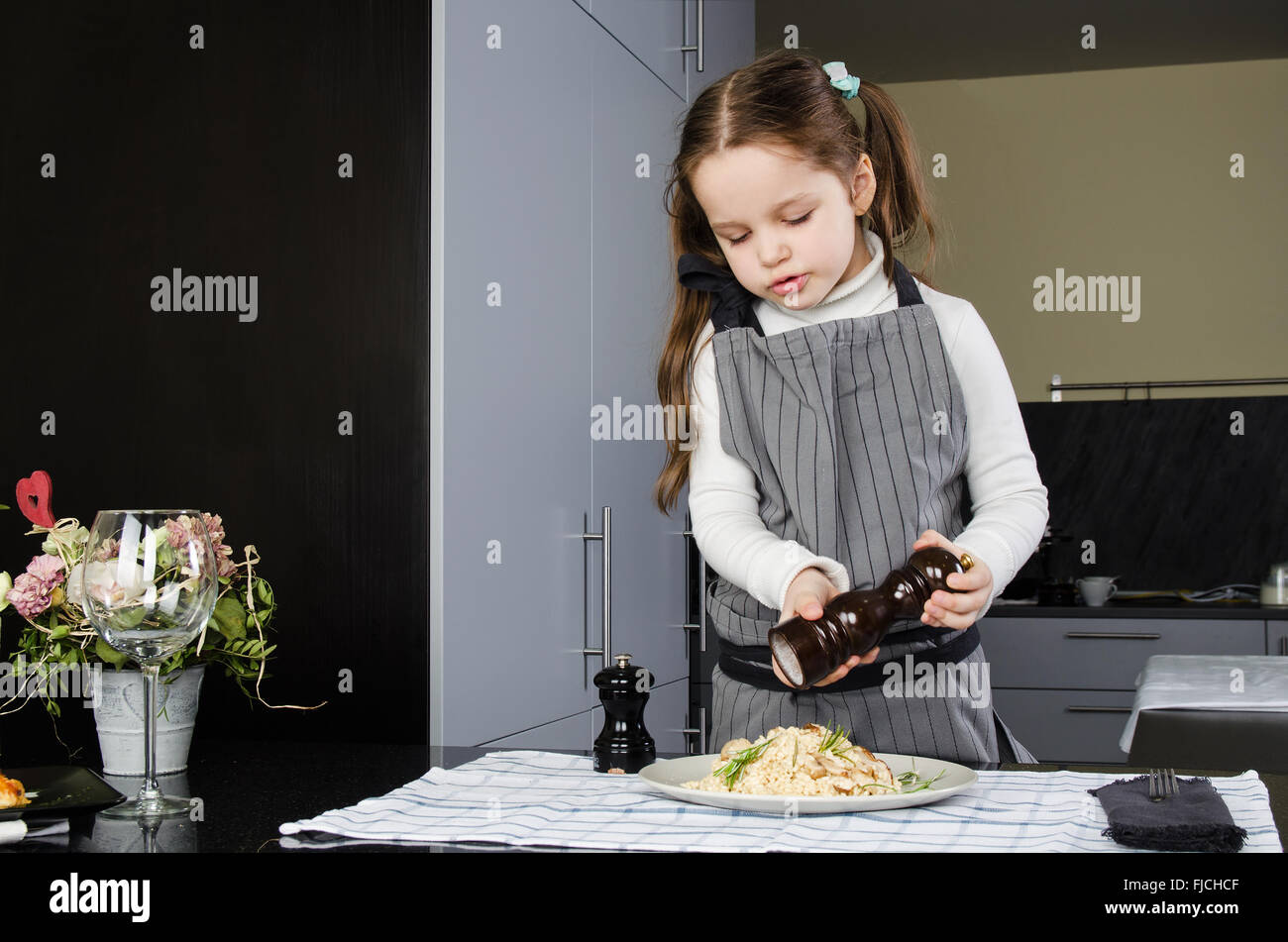 Cute little cook at the kitchen Stock Photo