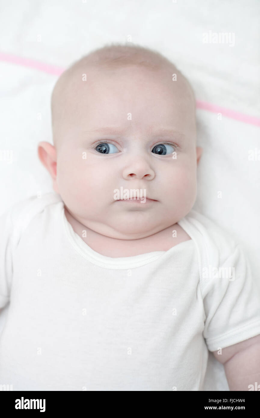 Baby girl posing with bright eyes, baby is newborn and very little Stock Photo