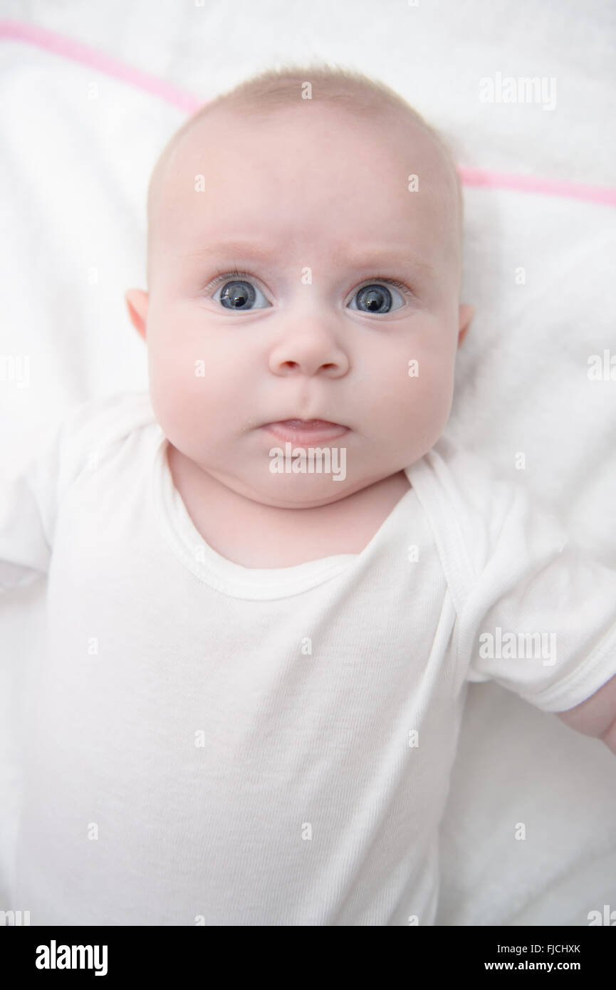 Baby girl posing with bright eyes, baby is newborn and very little Stock Photo