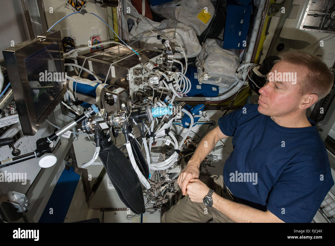 NASA astronaut Tim Kopra prepares to participate in an Airway Monitoring experiment aboard the International Space Station February 25, 2016 in Earth Orbit. Airway Monitoring studies the occurrence of airway inflammation in crewmembers, using ultra-sensitive gas analyzers to analyze exhaled air. This helps to highlight any health impacts and to maintain crewmember well-being on future human spaceflight missions. Stock Photo