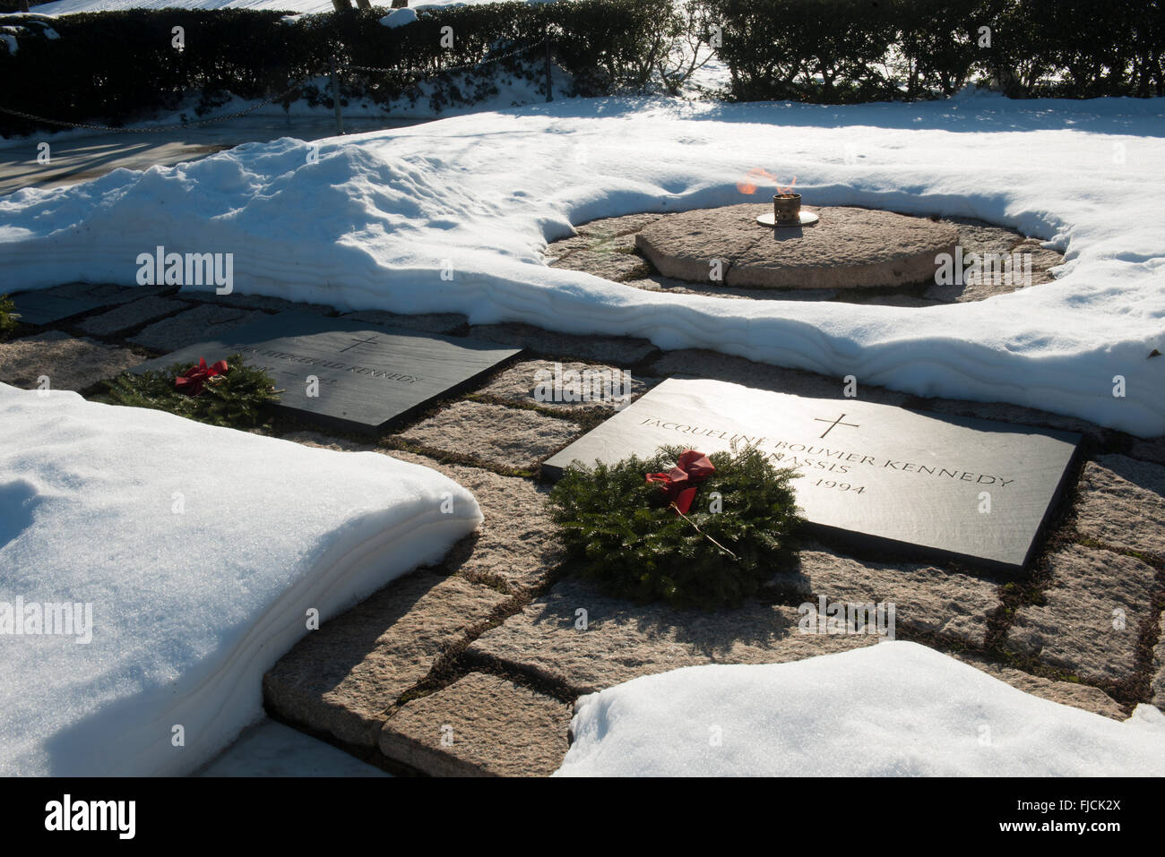 Snow blankets the tomb of President John F. Kennedy and First Lady Jacqueline Bouvier Kennedy gravesites and memorial at Arlington National Cemetery January 27, 2016 in Arlington, Virginia. Stock Photo