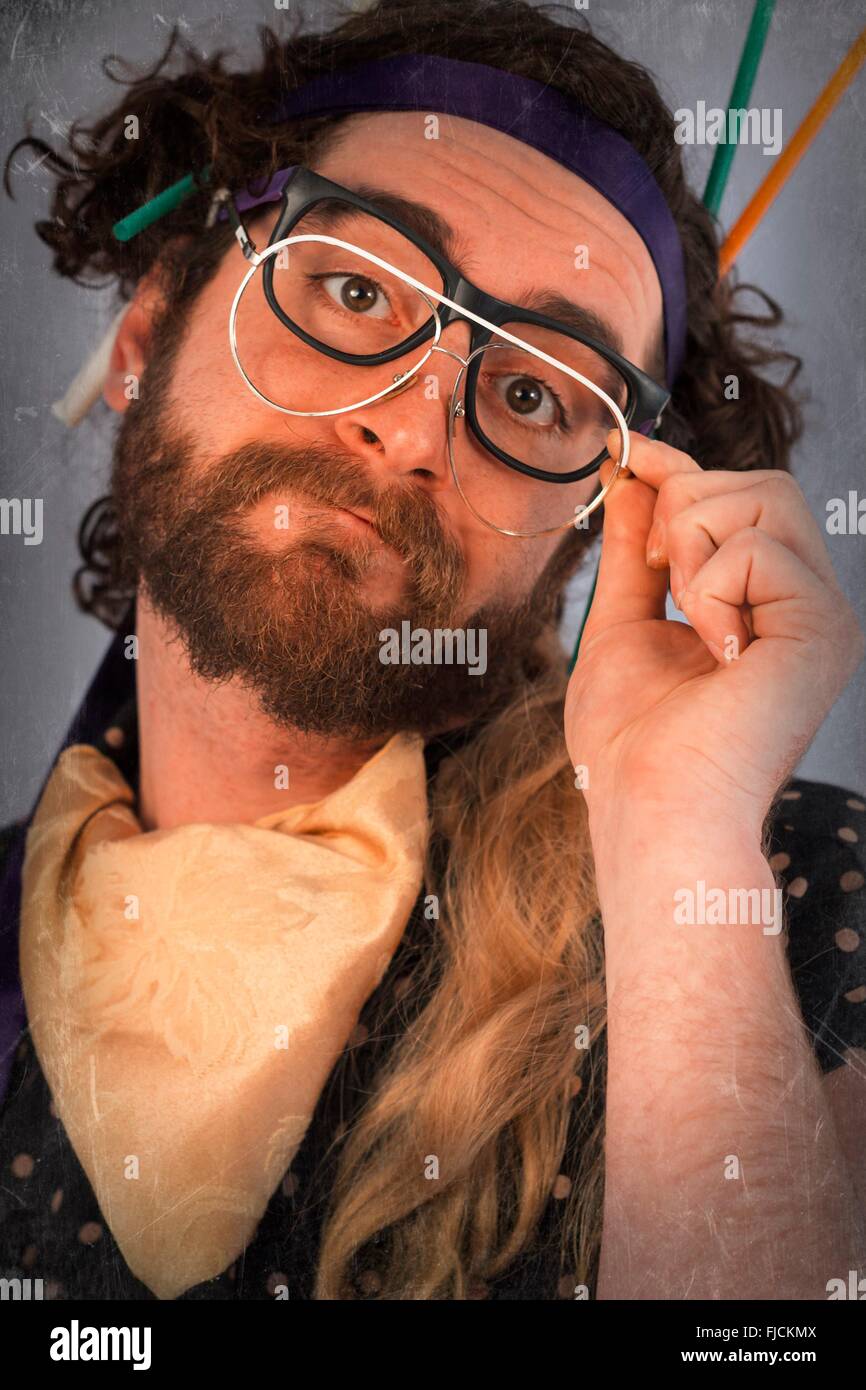 Bearded crazy person lunatic wearing several pairs of glasses Stock Photo