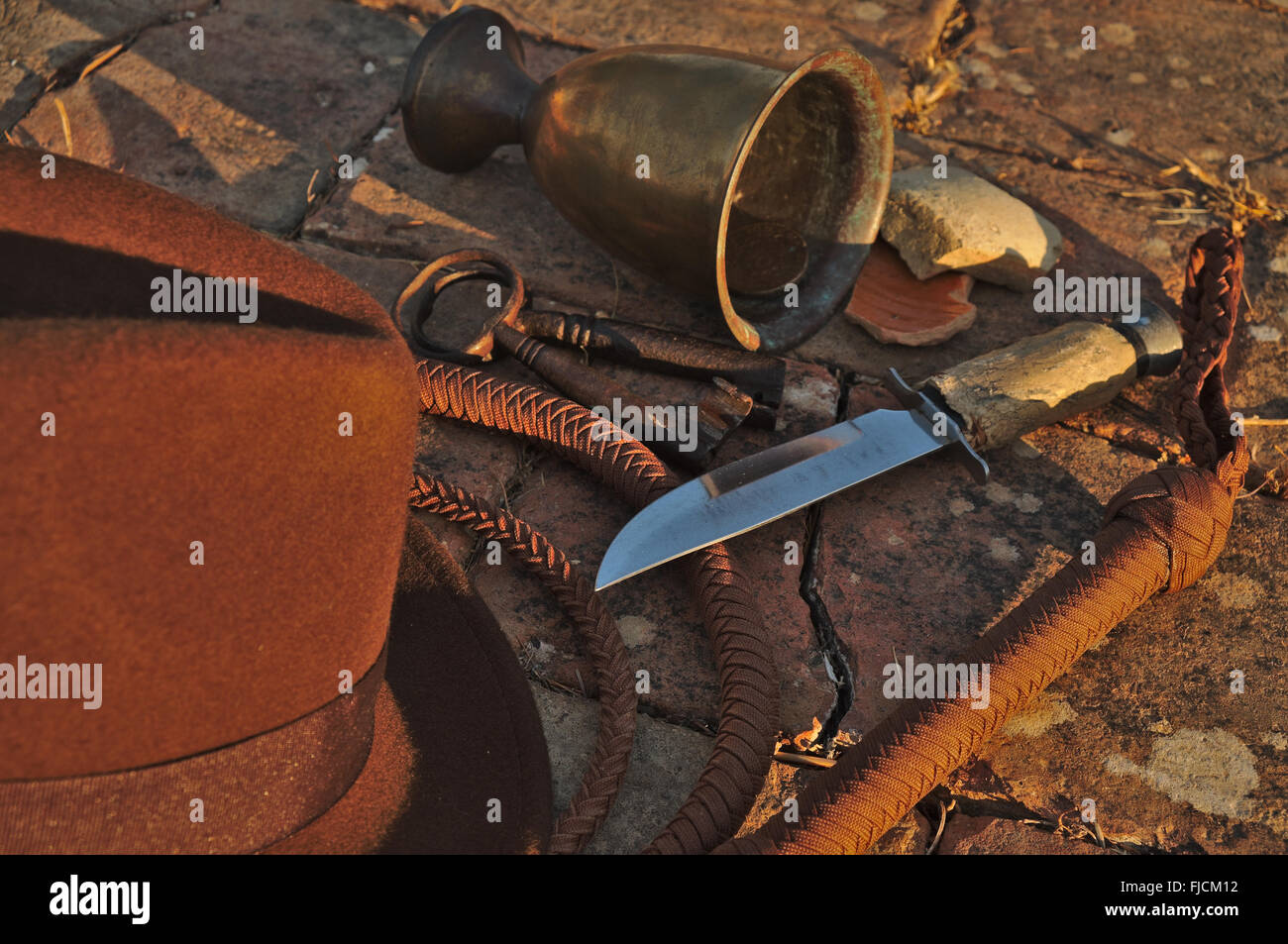 Indiana Jones related items: Fedora hat, whip, knife, antique skeleton keys and other artifacts. Themed photography Stock Photo