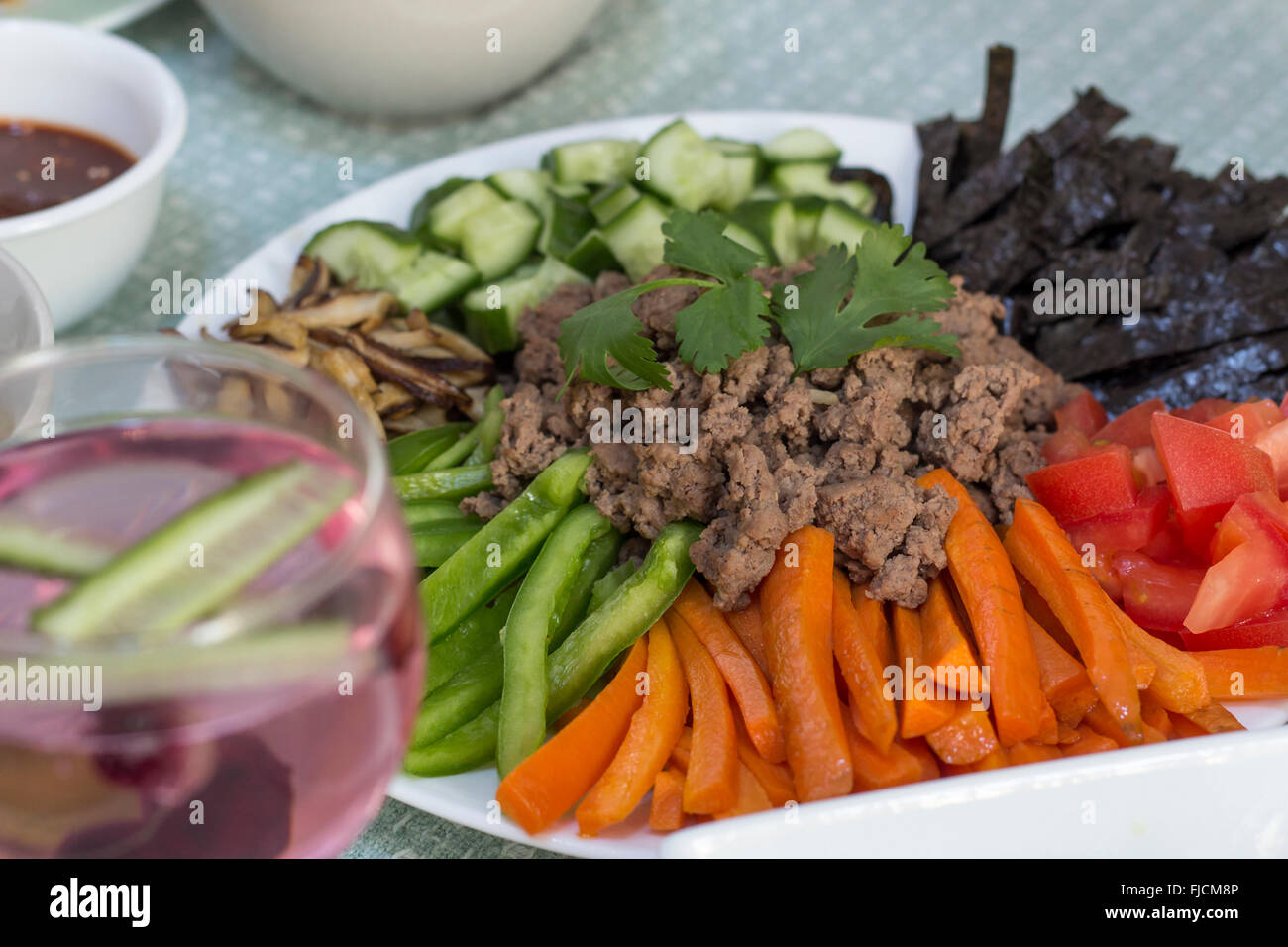 Korean beef bibimbap dinner with soju blueberry shrub  cocktail Stock Photo