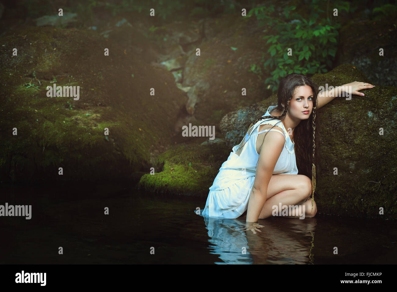 Beautiful woman posing in stream waters . Fantasy and surreal Stock Photo