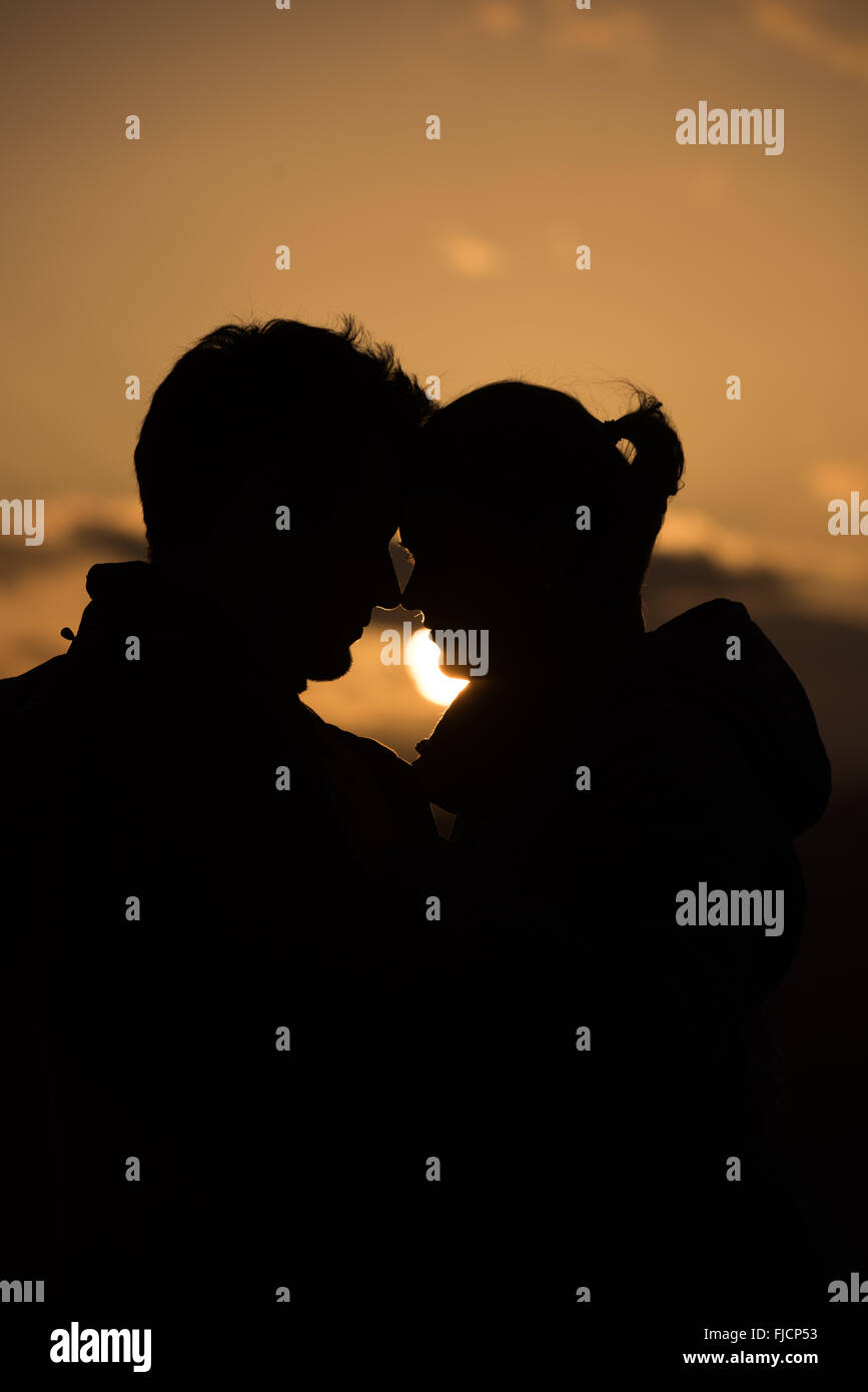 young couple kissing in sunset Stock Photo - Alamy