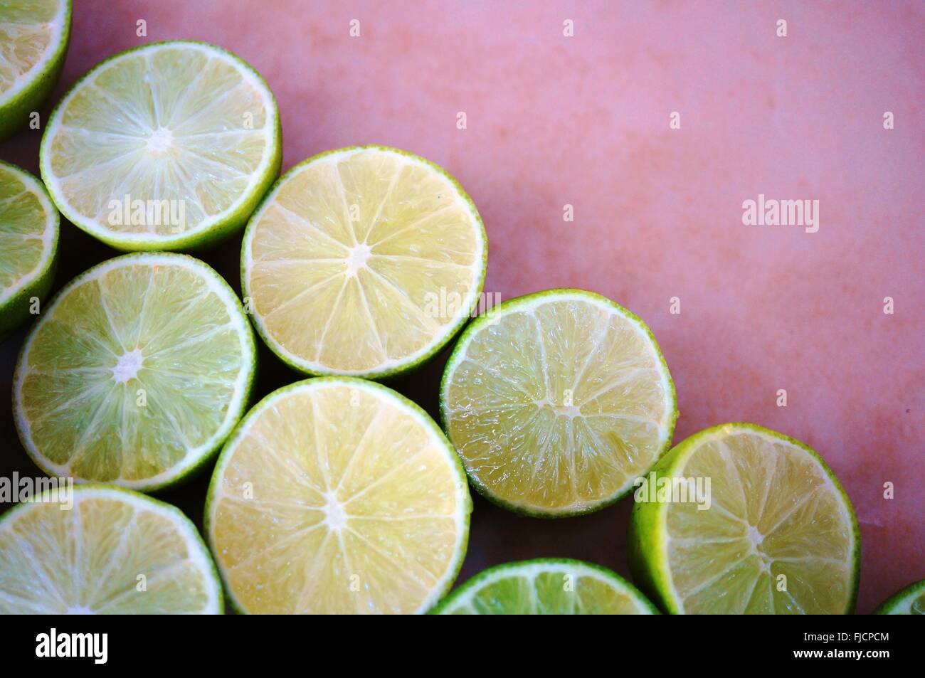 Juicy green limes cut in half on a platter Stock Photo Alamy