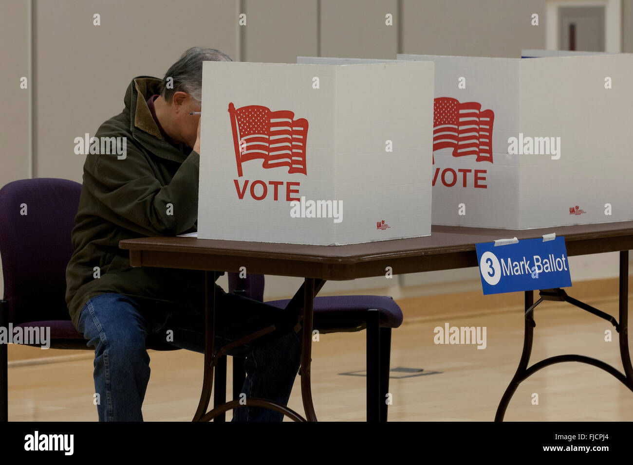 Arlington, Virginia, USA. 1st March, 2016. Virginians cast their votes in a pooling place for the US presidential primary in Arlington, on this Super Tuesday. Pictured: Male voter using voting booth. Credit:  B Christopher/Alamy Live News Stock Photo