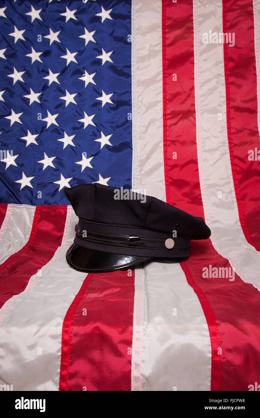 A police hat on an American flag background. Stock Photo