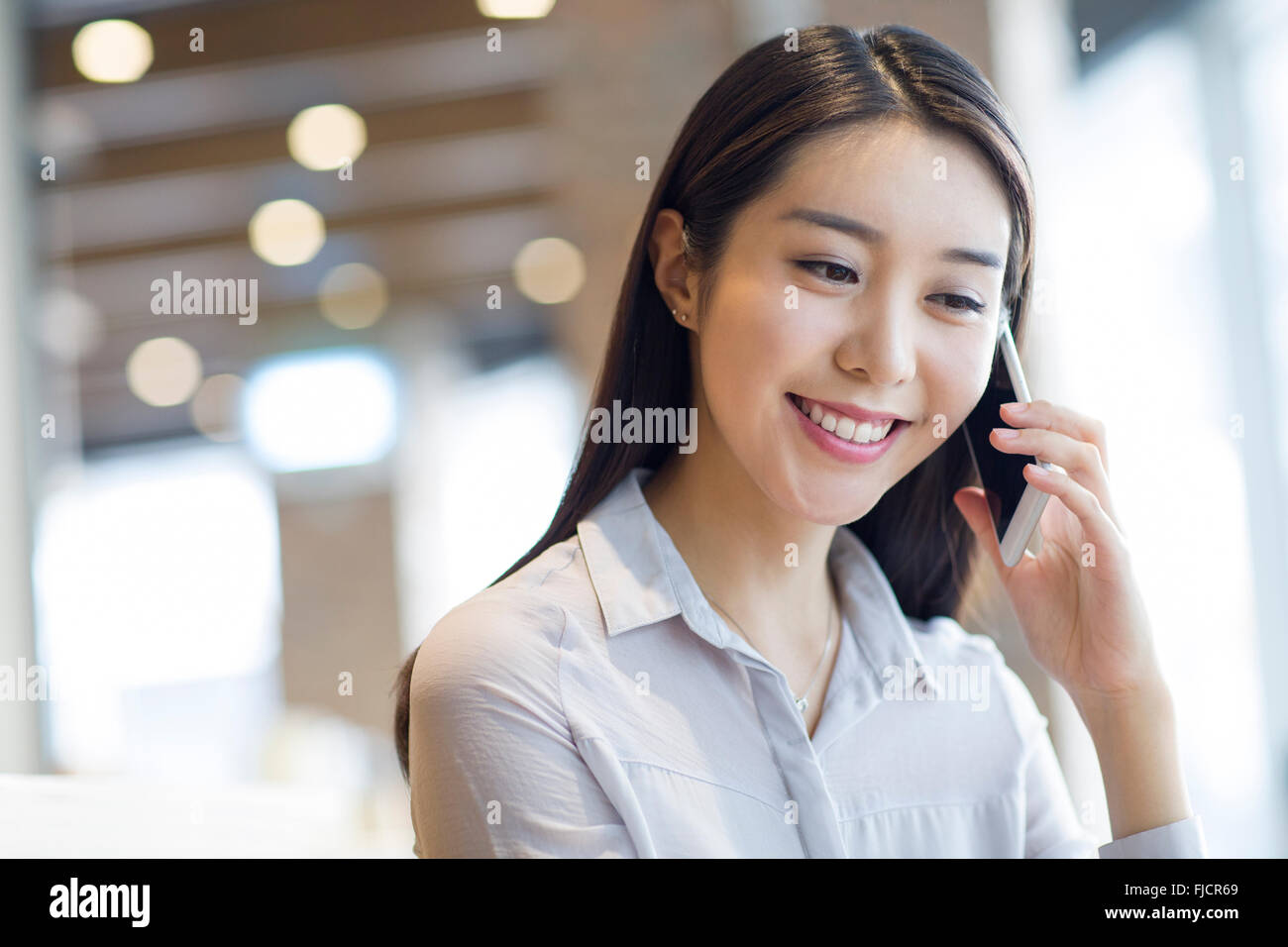 Young Chinese woman talking on the phone Stock Photo - Alamy