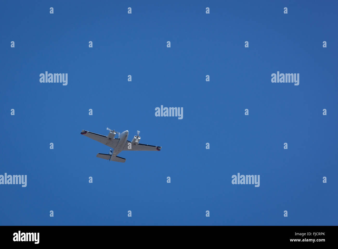 A propeller airplane flies in a clear blue sky Stock Photo - Alamy
