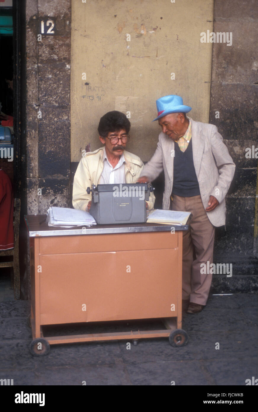 Public scribe helping a client in Plaza Santo Domingo, Mexico City, Mexico Stock Photo
