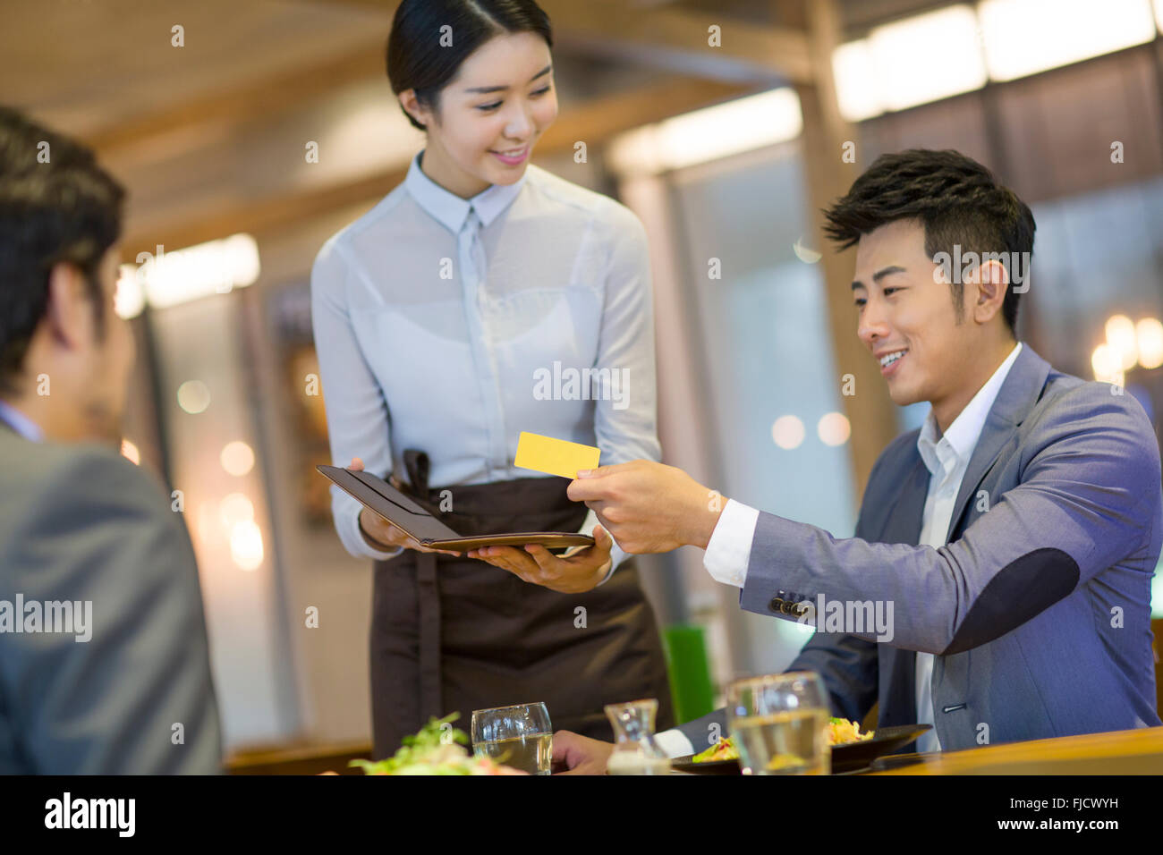 chinese businessman paying bill by credit card in restaurant stock photo alamy chinese businessman paying bill