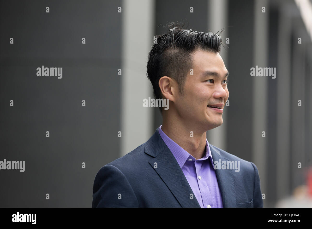 A happy looking Asian businessman Stock Photo - Alamy