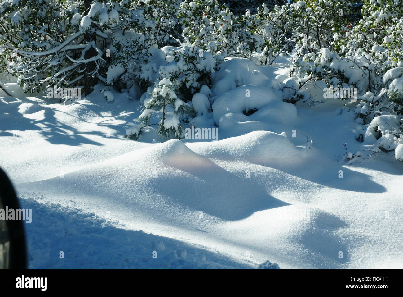 Ash Creek, California, with snow covered ground, shrubs along roadside, wild life area is frequented by visitors, campers and hu Stock Photo