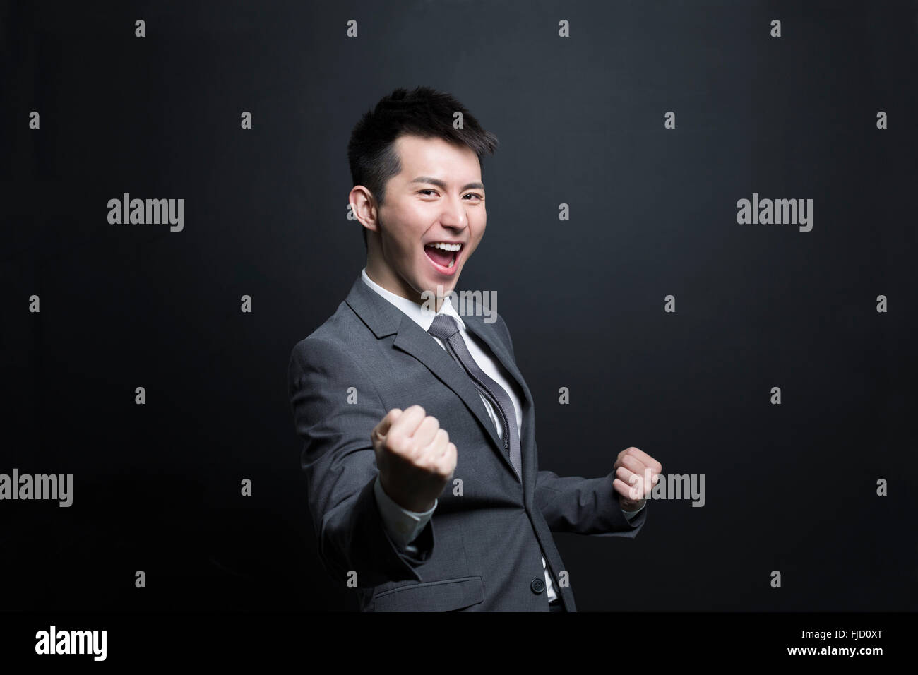 Excited Chinese businessman Stock Photo