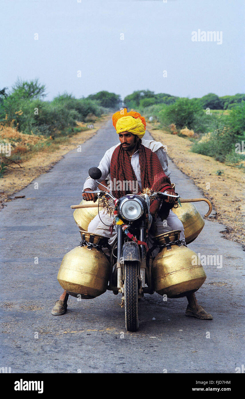 Man carrying water pot on motorcycle, jaipur, rajasthan, india, asia
