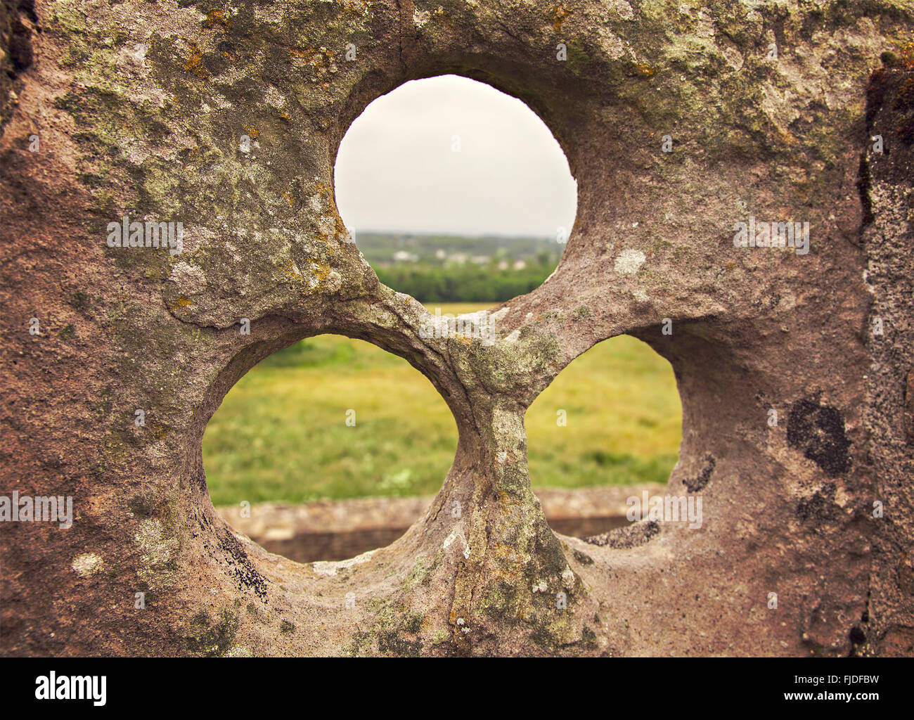 Image of lookout holes in historic building ruin. Craigmillar castle, Scotland. Stock Photo