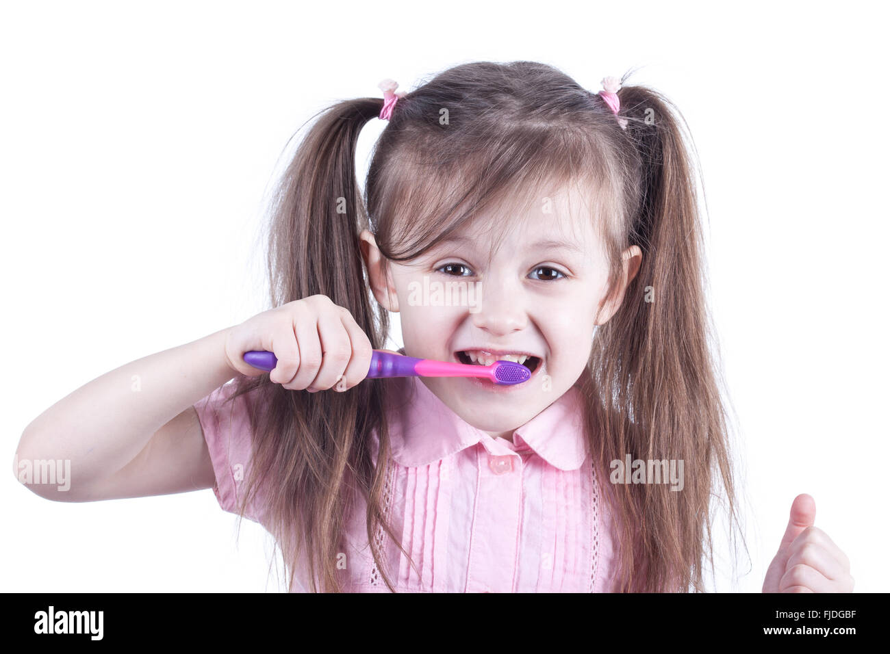 fun child cleaning teeth isolated on white background Stock Photo