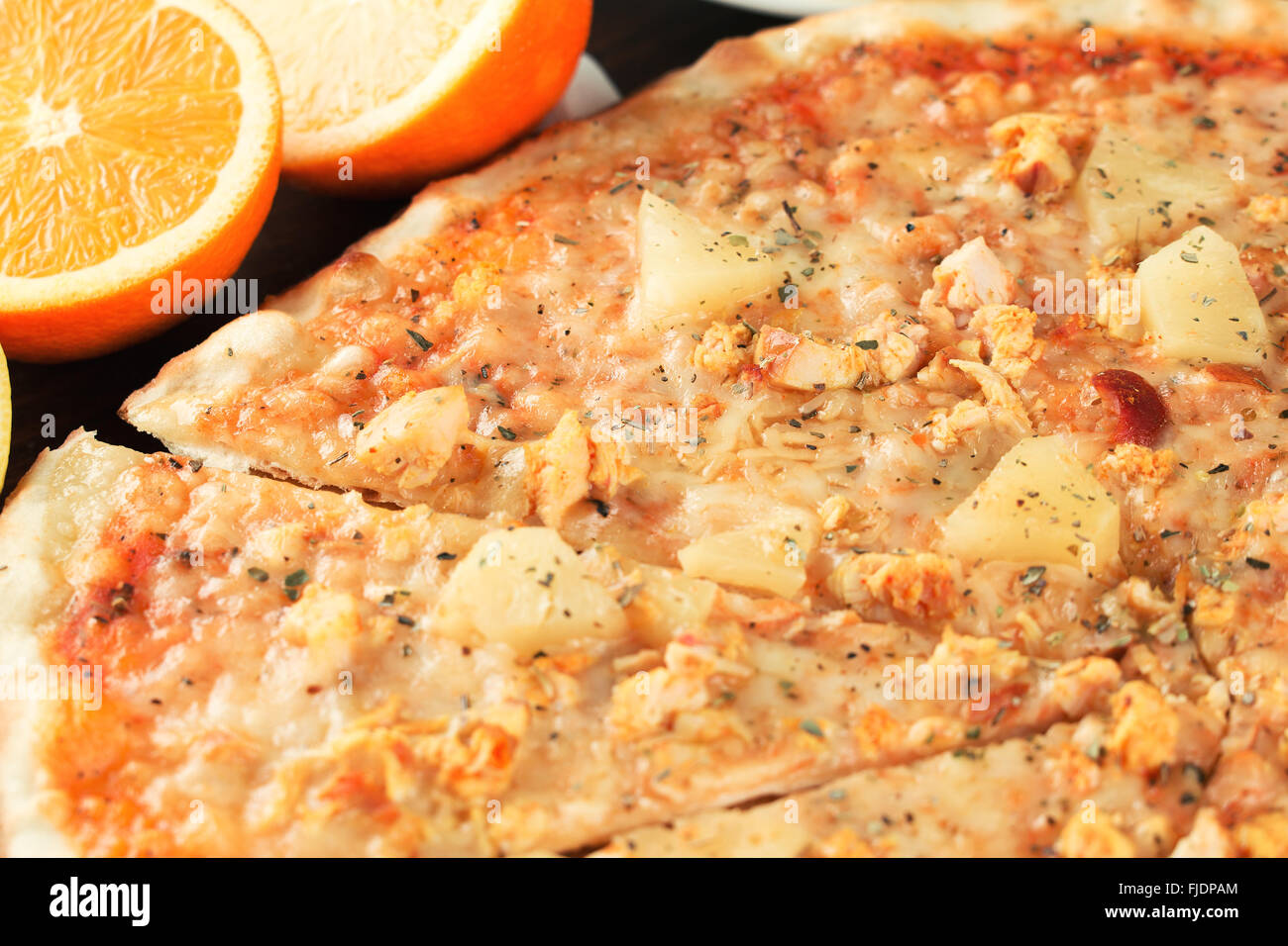 Pizza with exotic fruit and chicken close-up. Shallow depth of field Stock Photo