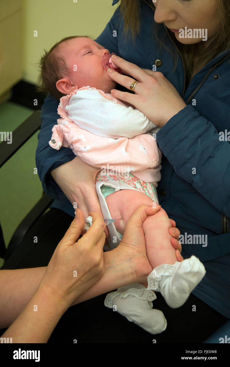 Baby having immunization vaccination injections Stock Photo