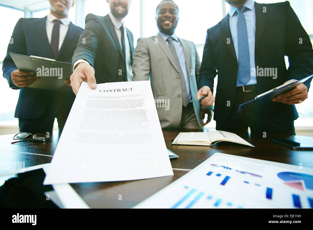 Business group suggesting you to sign a contract Stock Photo