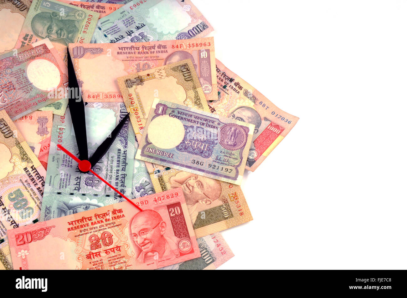 'Time is money' concept - clock and  Indian rupee Stock Photo