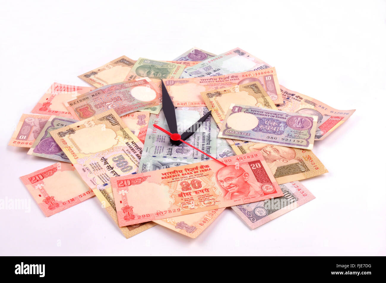 'Time is money' concept - clock and  Indian rupee Stock Photo