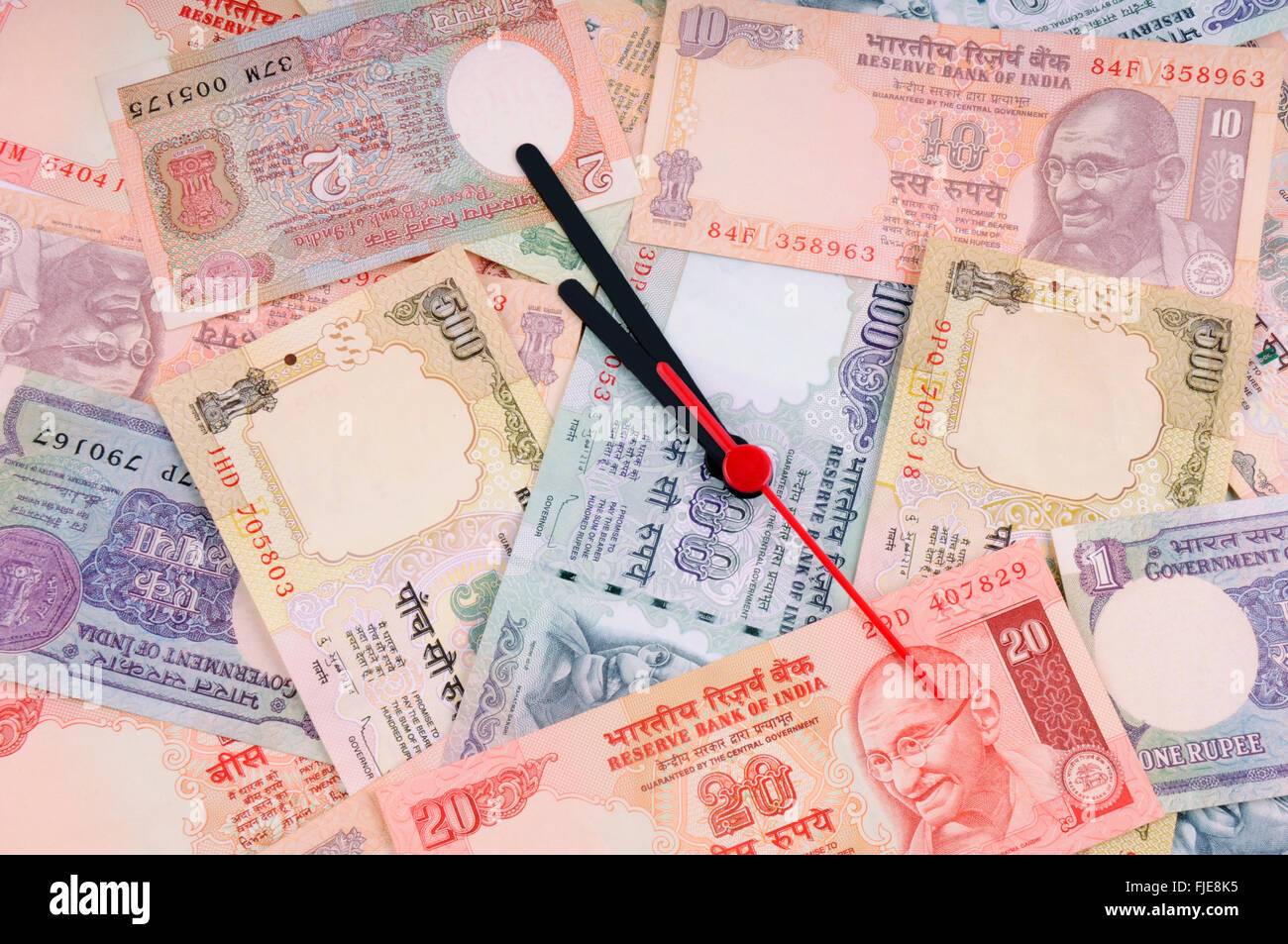 'Time is money' concept - clock and  indian rupee Stock Photo