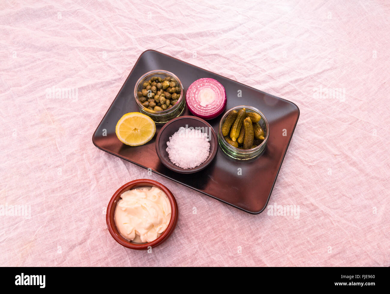 Tray with individual ingredients to make tartar sauce, mayonnaise, salt