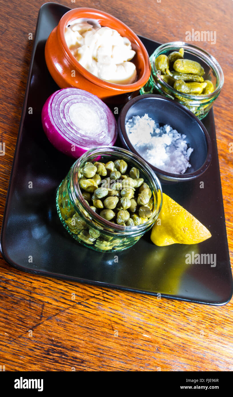 Tray with individual ingredients to make tartar sauce, mayonnaise, salt