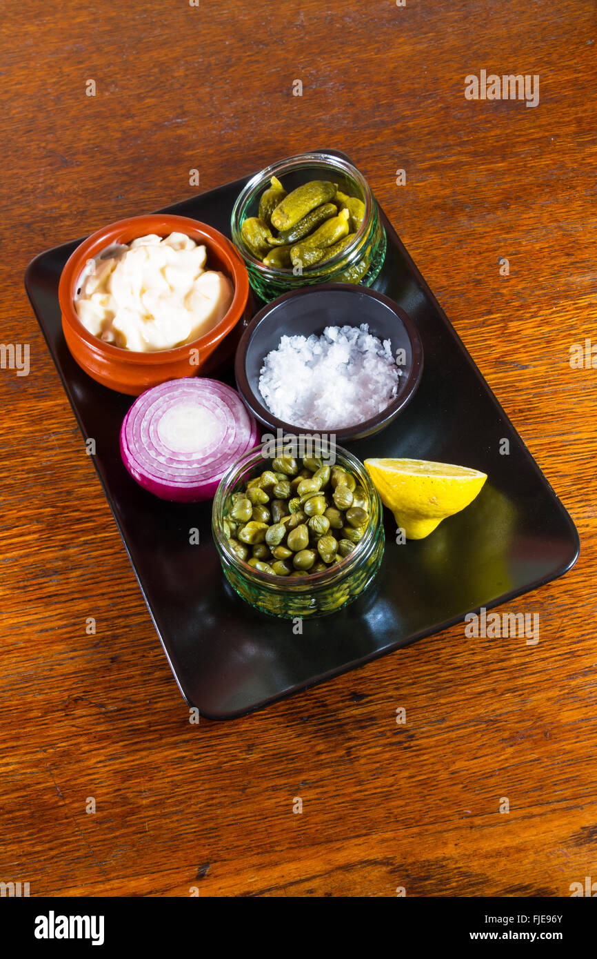 Tray with individual ingredients to make tartar sauce, mayonnaise, salt