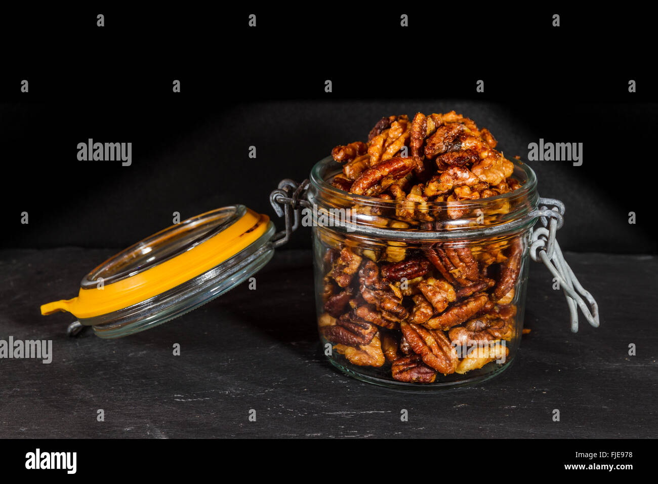 Pecan nuts and walnuts roasted with garlic and rosemary in jar. Dark background Stock Photo Alamy