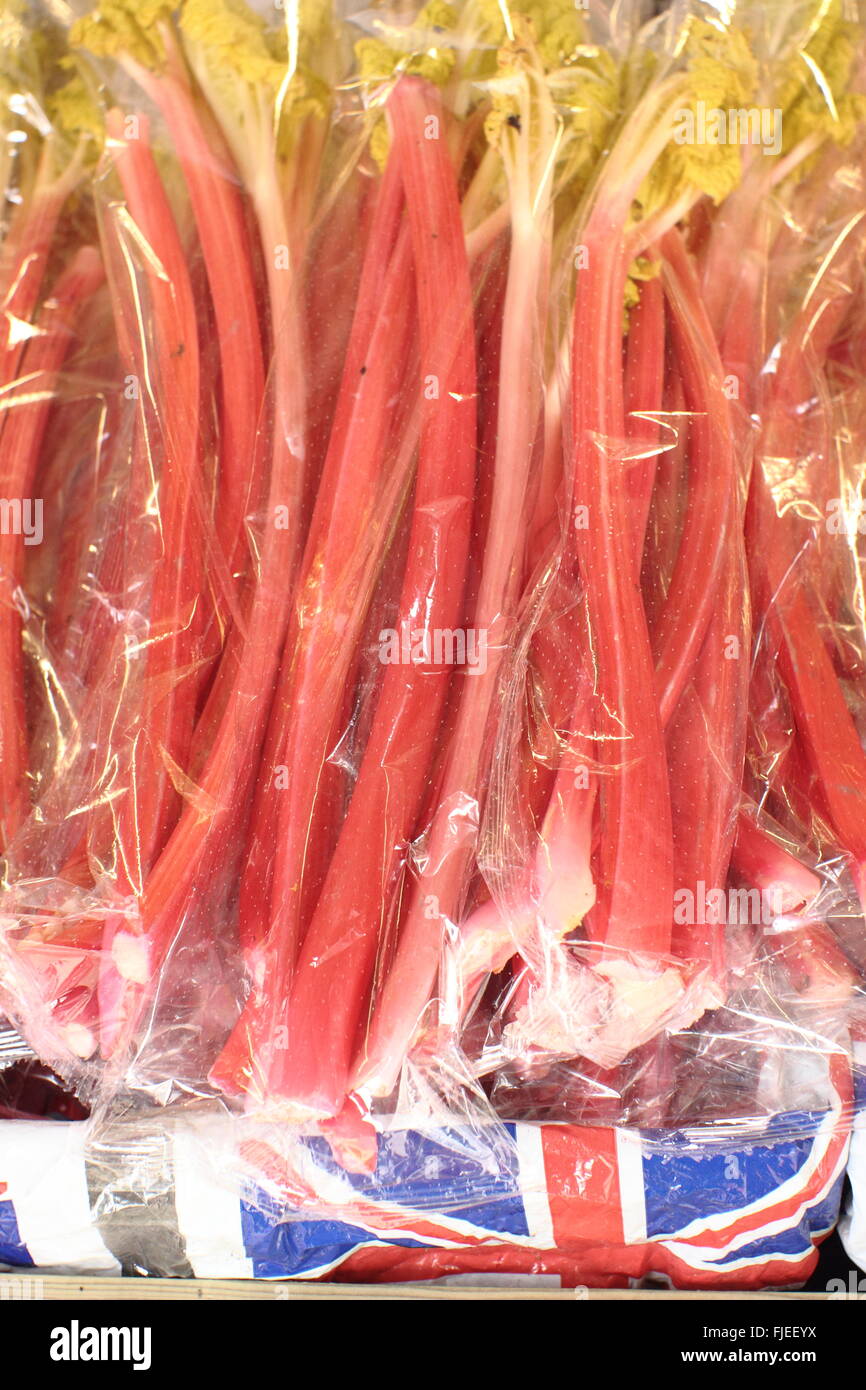 Forced Yorkshire rhubarb stems for sale on a market stall at the rhubarb and food festival in the centre of Wakefield city, UK Stock Photo