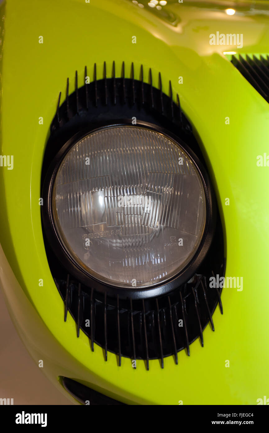 A close-up of the 'eyelashes' around the  headlight of a  yellow 1960's Lamborghini Miura P400 Stock Photo