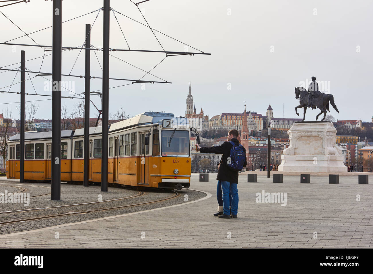 BUDAPEST, HUNGARY - FEBRUARY 02: Young couple taking selfie next to tram line number two near Hungarian Parliament building, wit Stock Photo