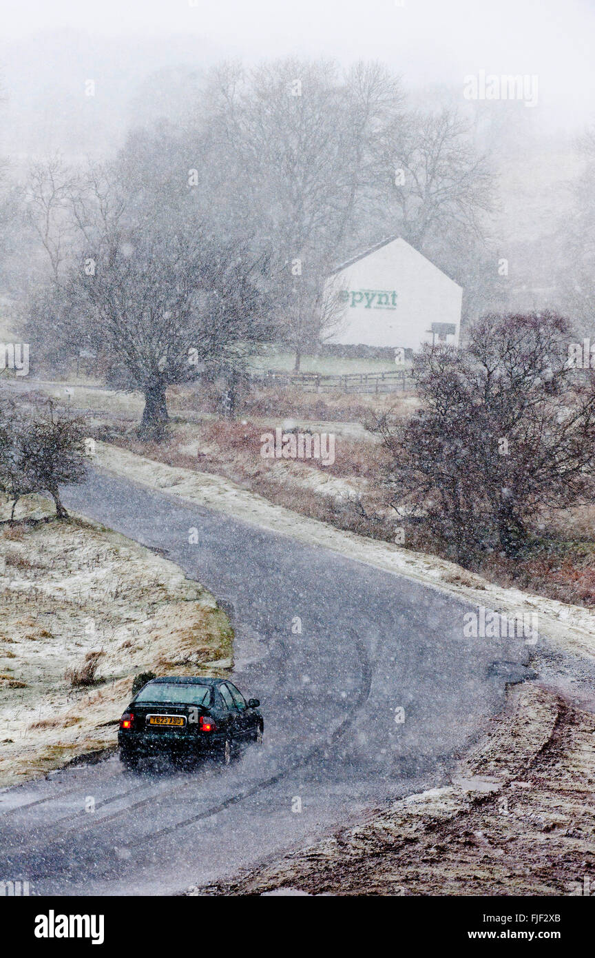 Upper Chapel, Powys, Wales, UK. 2nd March 2016. UK Weather: A motorist negotiates the small road during a blizzard between Upper Chapel & Garth, this morning on the high moorland of the Mynydd Epynt range. A blizzard of snow, hail, and sleet with winds gusting up to approximately 50mph hit high land in Powys, Wales this morning. Credit:  Graham M. Lawrence/Alamy Live News. Stock Photo