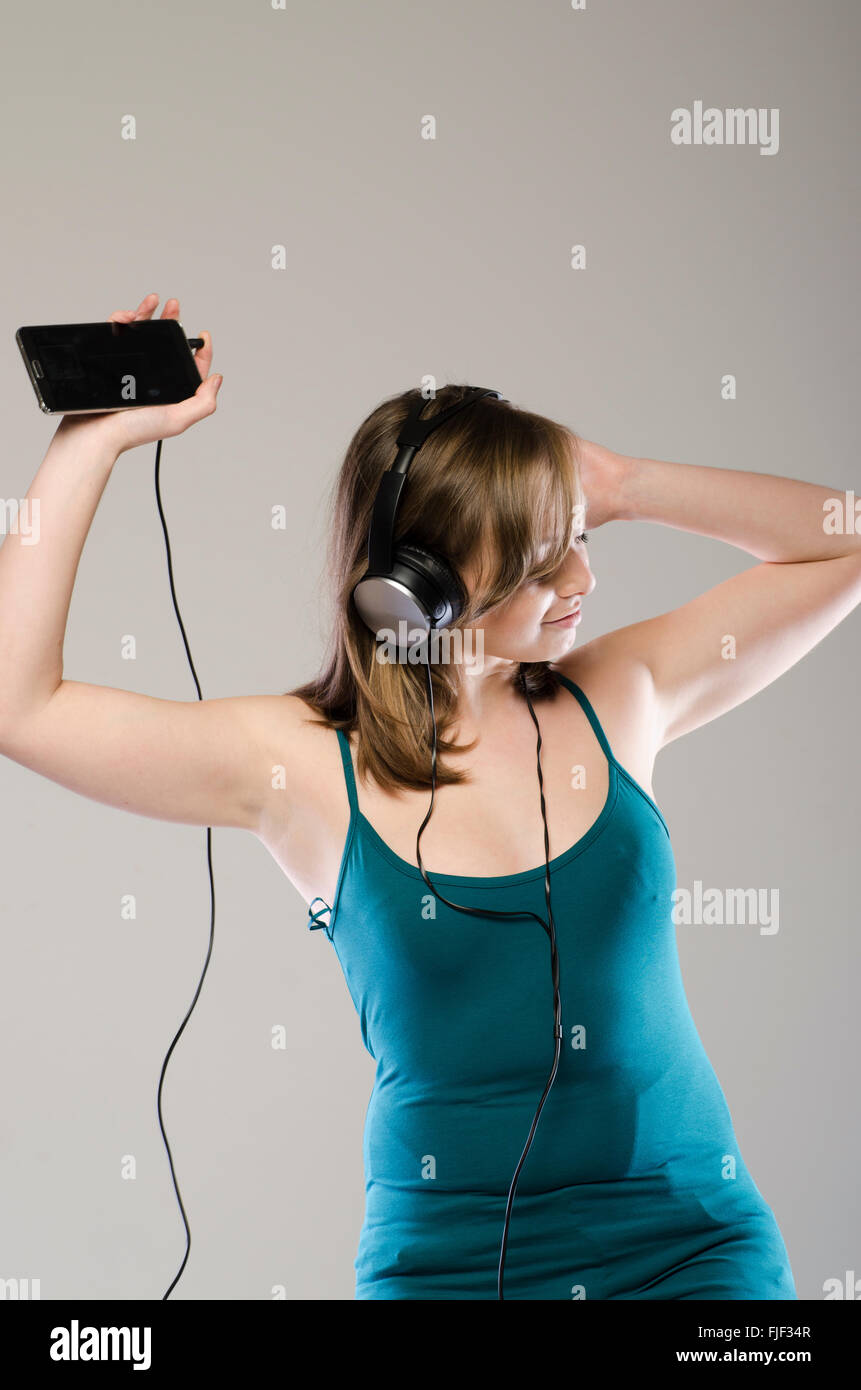 Happy young woman listening to music Stock Photo - Alamy