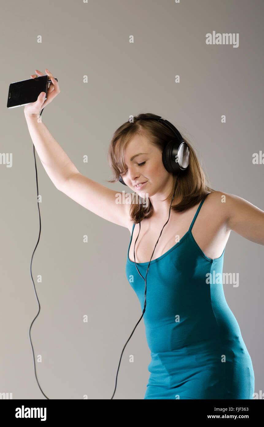 Happy young woman listening to music Stock Photo - Alamy