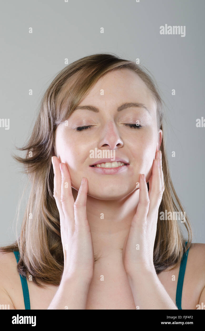 Happy young woman smiling Stock Photo - Alamy