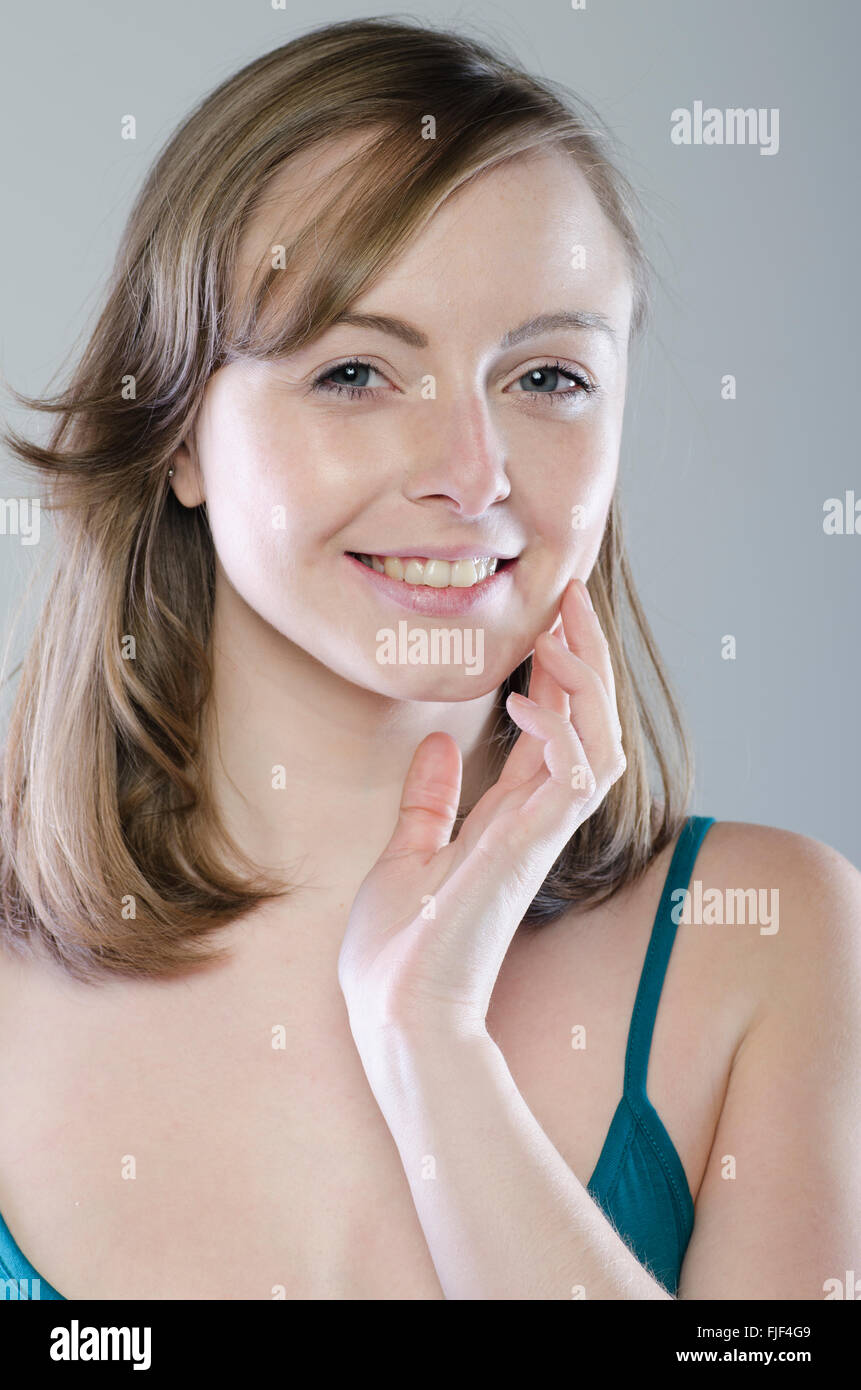 Happy young woman smiling Stock Photo - Alamy
