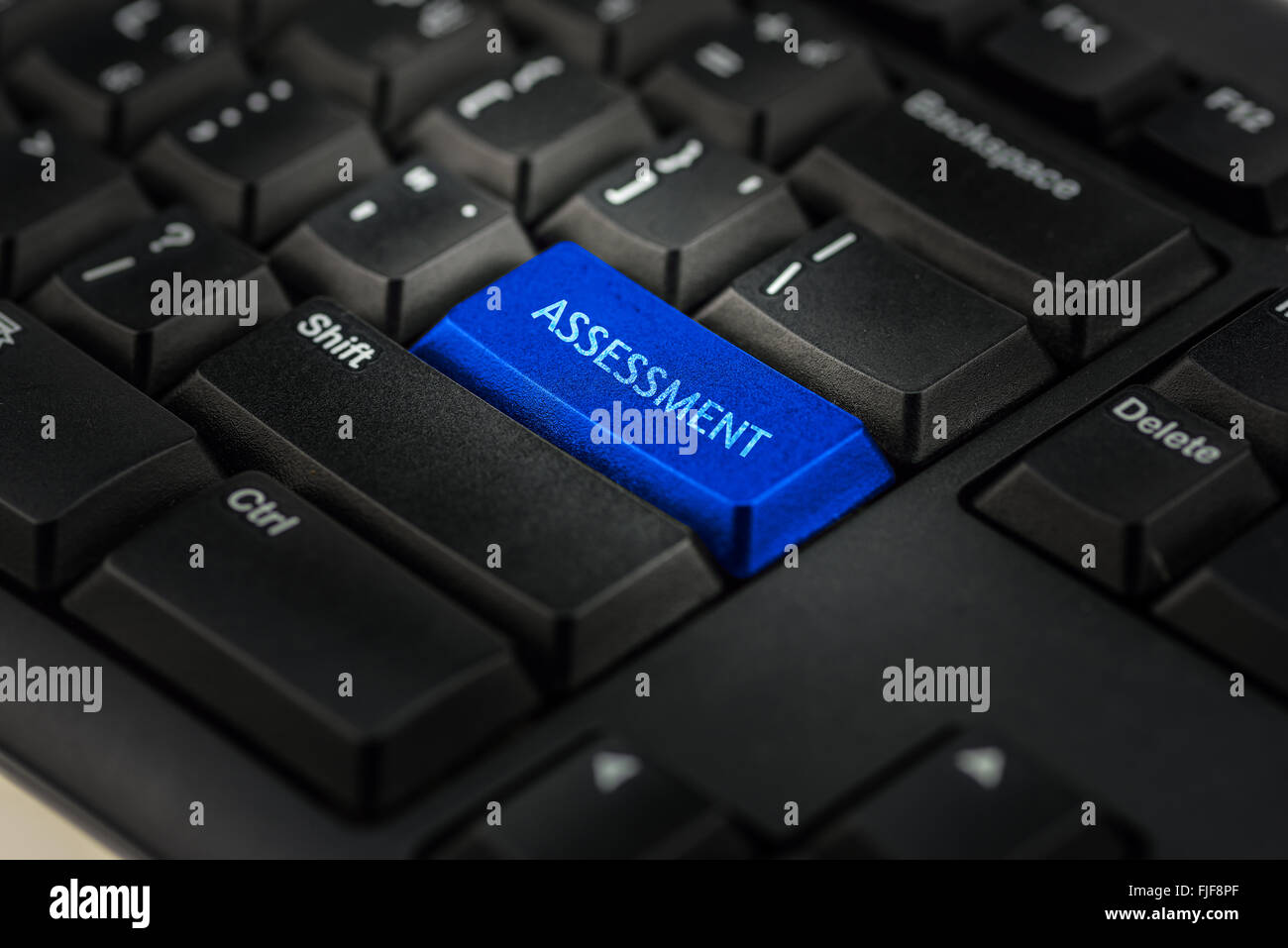 Close-up view on conceptual keyboard - assessment (blue key) Stock Photo