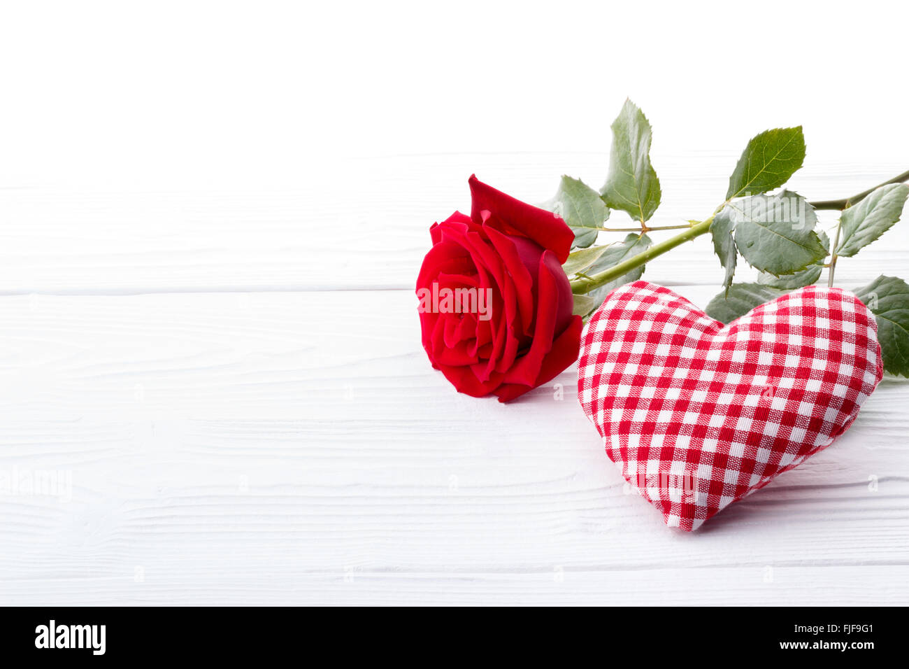 Red rose and a heart on white background Stock Photo - Alamy