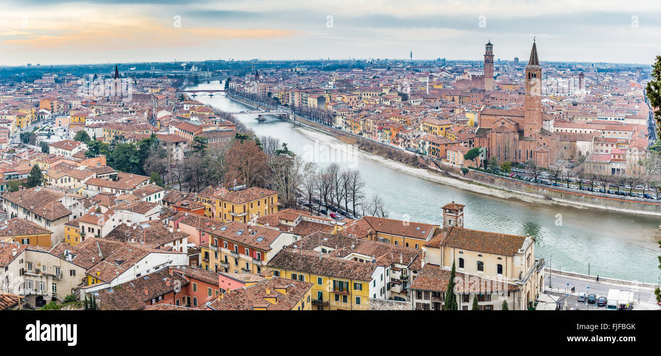 panorama of the Adige River as it passes through the houses and historical buildings of Verona in Italy, known as romantic city of love because Romeo and Juliet by Shakespeare was set here Stock Photo