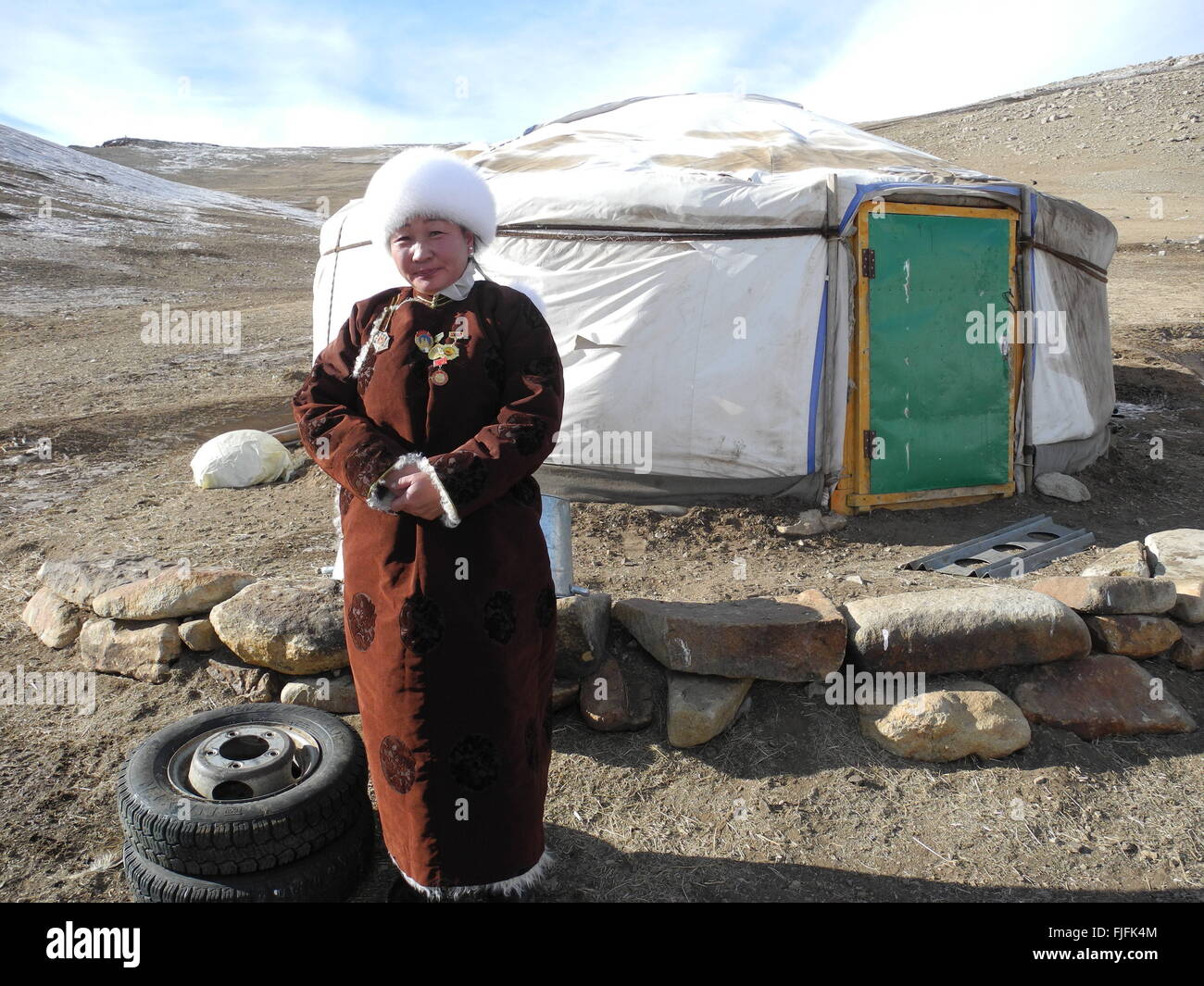 Herdswoman Uranchimeg stands in front of her family's yurt despite the inhospitable climate in Bayankhongor Province, Mongolia, 24 February 2016. 'We are noticing climate change in the region,' Uranchimeg says. There is less vegetation but more rodents in the shorter grasses. 'This is a great problem, since they eat away the grass for our livestock.' Photo: JOANNA CHIU/dpa Stock Photo