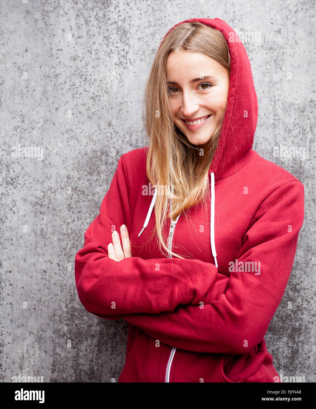 Attractive young woman wearing red hoodie Stock Photo