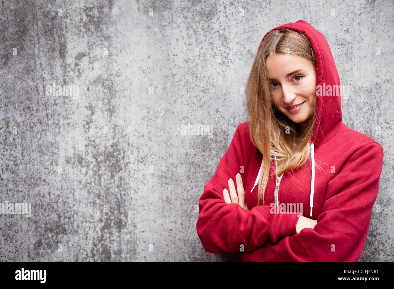 Attractive young woman wearing red hoodie Stock Photo