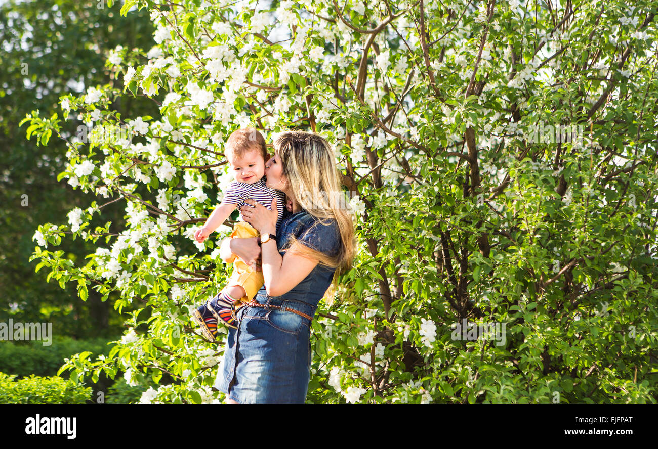 Boy holding flowers for mother hi-res stock photography and