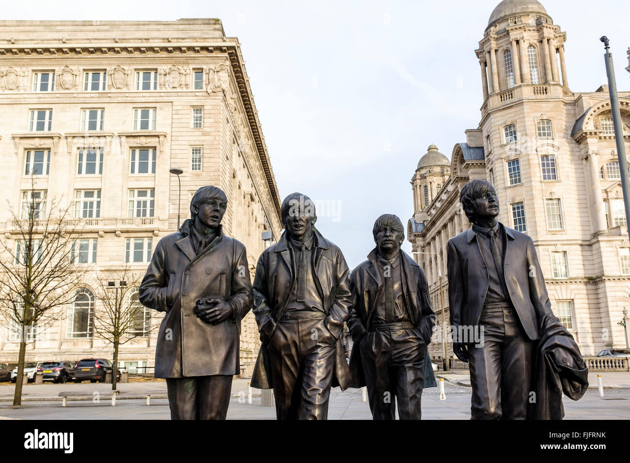 The Beatles statues at the pier head in Liverpool  UK with the Royal LIver Building in the background Stock Photo