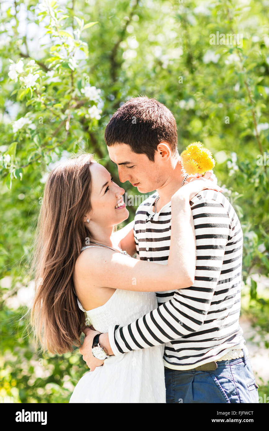 Romantic young couple standing under blossom tree Stock Photo - Alamy